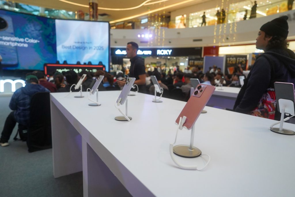 Realme 14 Series demo units on display tables at the IOI City Mall launch