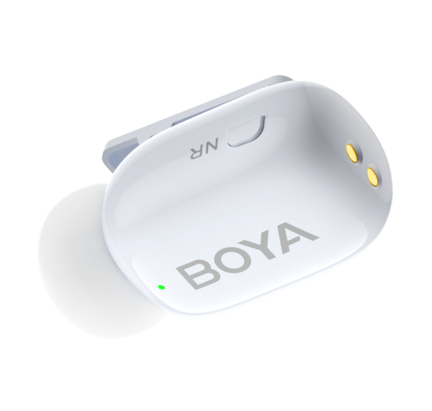 Close-up of white BOYA Mini mic showing NR button and gold charging pins